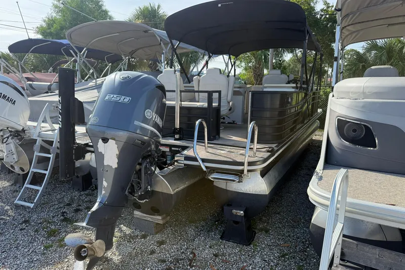 Slide: The Image of 2016 Bennington 2550 RBR pontoon boat with Yamaha 250 engine, docked outdoors. - 1
