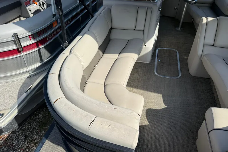 Slide: The Image of 2016 Bennington 2550 RBR boat interior with beige seating and carpeted floor. - 12