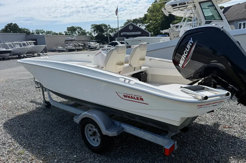 Slide: The Image of 2023 Boston Whaler 160 Super Sport boat on trailer, featuring a Mercury outboard motor. - 2