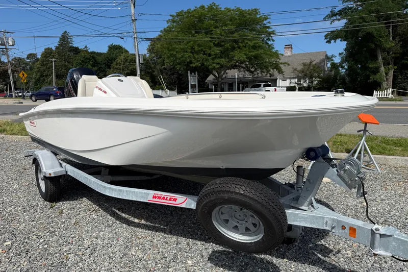 Slide: The Image of 2023 Boston Whaler 160 Super Sport boat on trailer, parked outdoors. - 1
