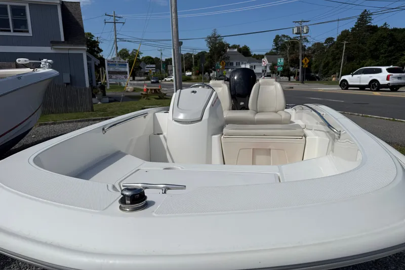 Slide: The Image of 2023 Boston Whaler 160 Super Sport boat, sleek design, parked outdoors on a sunny day. - 3