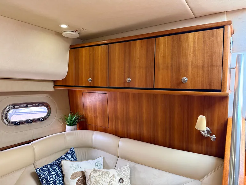Slide: The Image of The interior cabin of the 2006 Tiara Yachts 4300 Sovran features elegant woodwork and comfortable seating. - 38