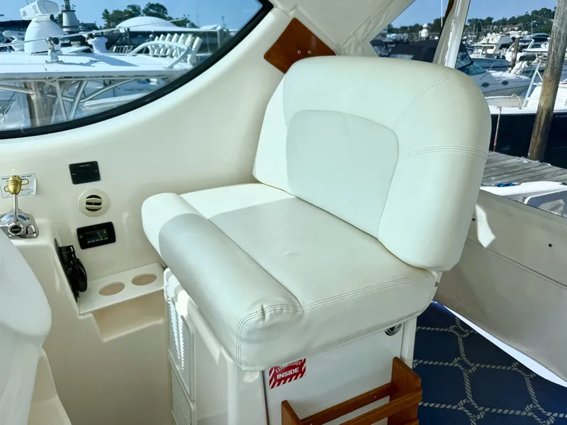 Slide: The Image of A luxurious white captain's seat on a 2006 Tiara Yachts 4300 Sovran. - 29