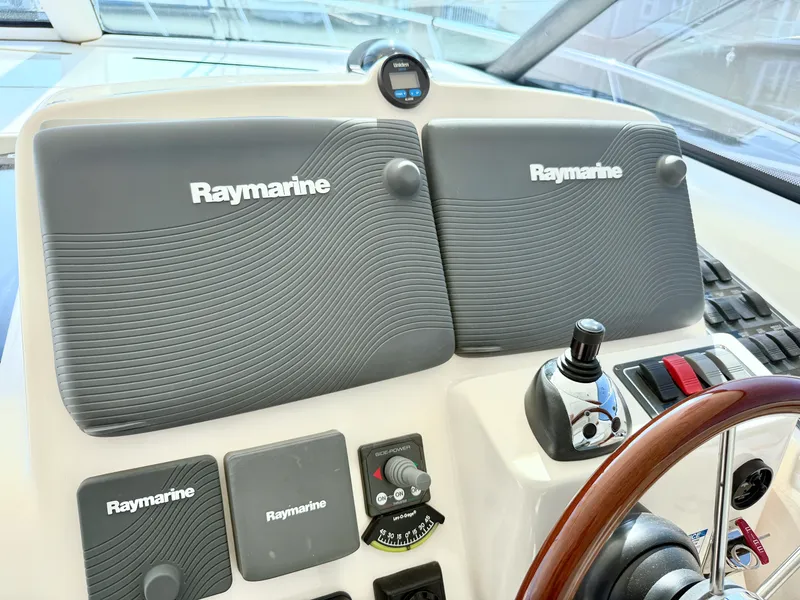 Slide: The Image of The image shows the dashboard of a 2006 Tiara Yachts 4300 Sovran with Raymarine electronics. - 34