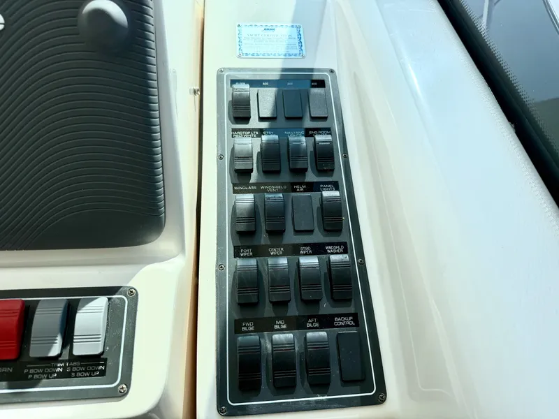 Slide: The Image of Control panel with multiple toggle switches and labels on a yacht. - 32