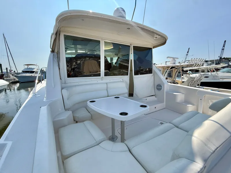 Slide: The Image of 2006 Tiara Yachts 4300 Sovran with spacious cockpit and white upholstery at the marina. - 10