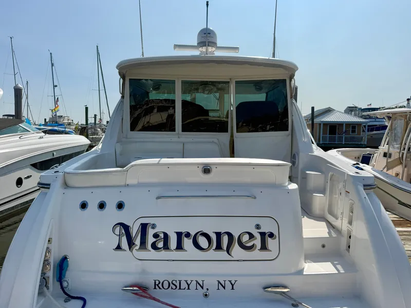 Slide: The Image of A 2006 Tiara Yachts 4300 Sovran docked at a marina. The name "Maroner" is visible on the stern. - 7