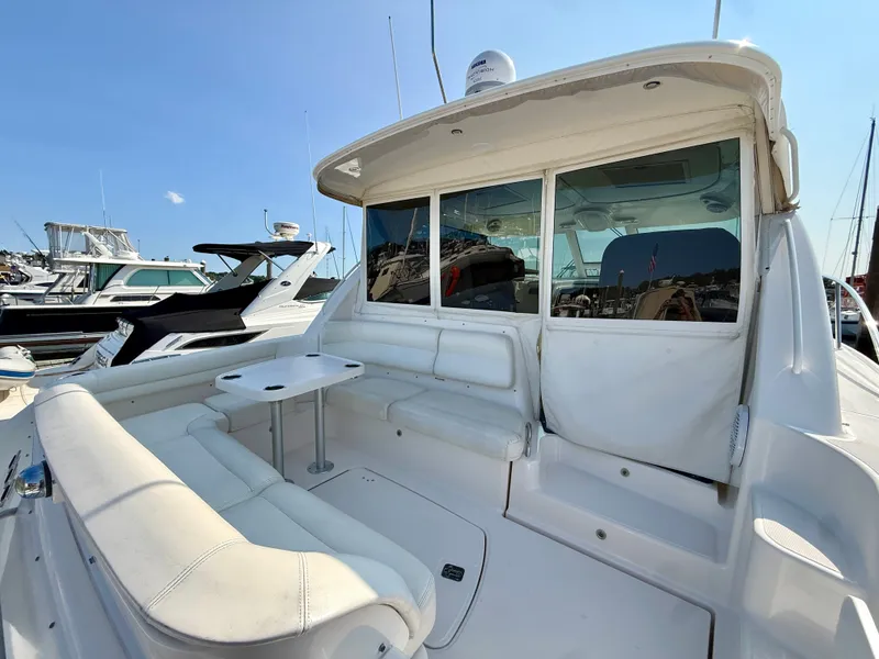 Slide: The Image of The 2006 Tiara Yachts 4300 Sovran features a spacious cockpit with white upholstery and a small table. - 9