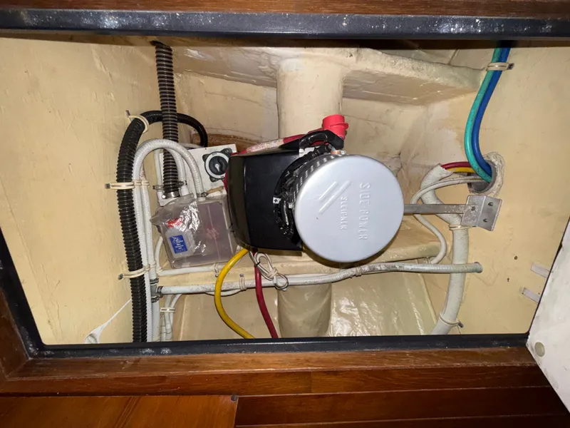 Slide: The Image of An engine compartment with a motor and various cables and hoses. - 43