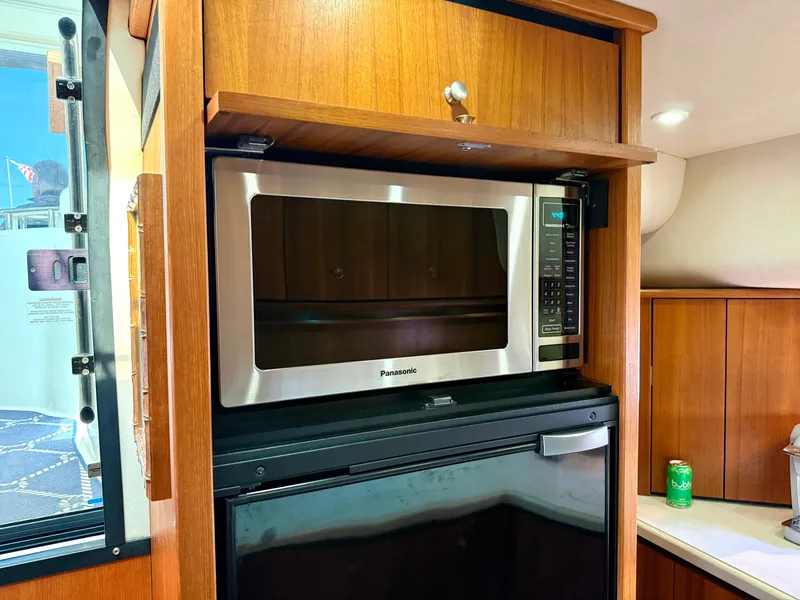 Slide: The Image of The galley of a 2006 Tiara Yachts 4300 Sovran features a microwave and a refrigerator. - 46