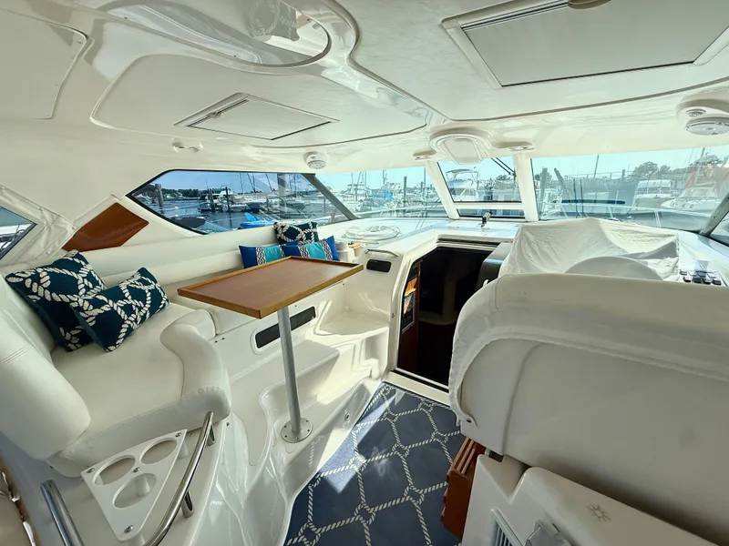 Slide: The Image of Interior of a 2006 Tiara Yachts 4300 Sovran with elegant seating area and table. - 17