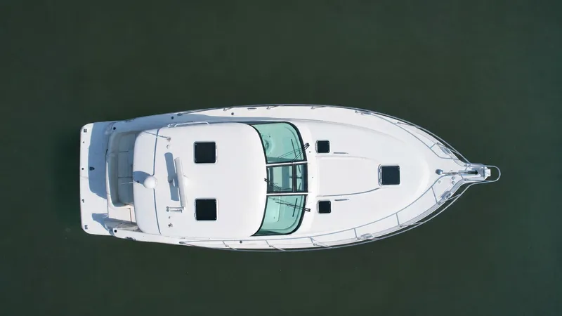Slide: The Image of Aerial view of a white 2006 Tiara Yachts 4300 Sovran on calm water. - 2