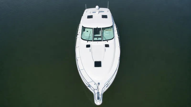Slide: The Image of Aerial view of a white 2006 Tiara Yachts 4300 Sovran on calm water. - 3