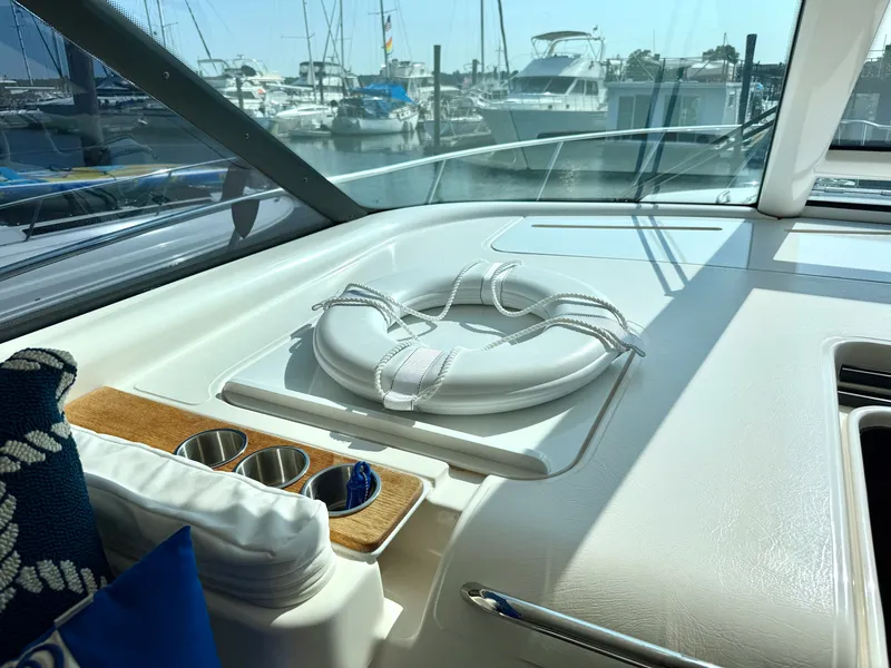 Slide: The Image of The cockpit of a 2006 Tiara Yachts 4300 Sovran with a life ring and cup holders. - 19