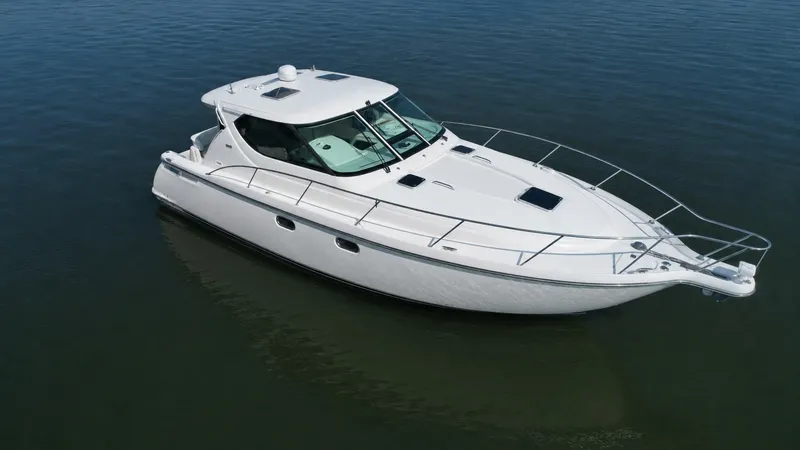 The Image of A 2006 Tiara Yachts 4300 Sovran on calm water, featuring a sleek white hull. - 0