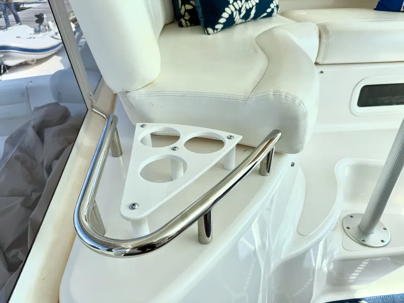 Slide: The Image of The 2006 Tiara Yachts 4300 Sovran features a white seating area with blue cushions and a cup holder. - 28