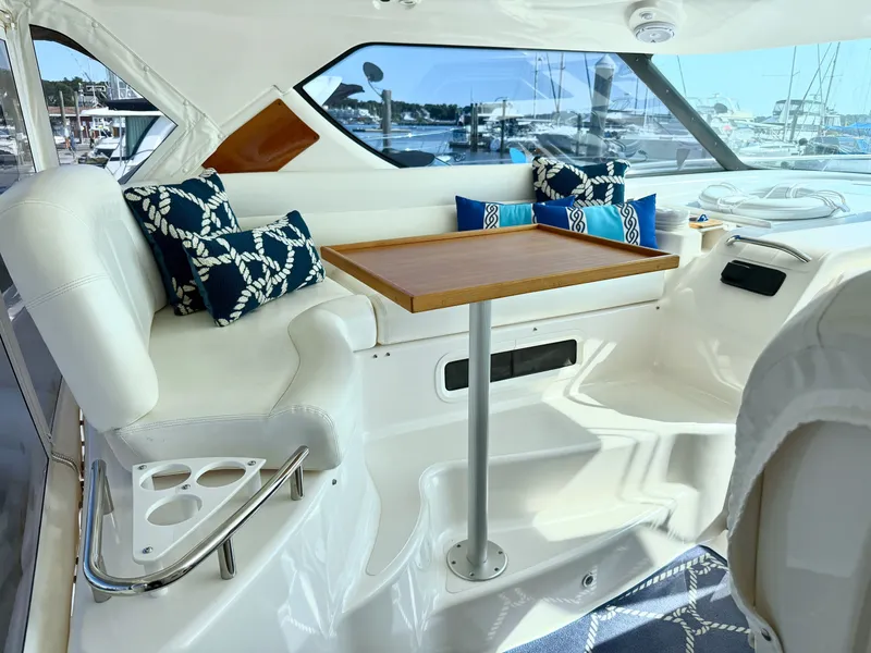 Slide: The Image of The 2006 Tiara Yachts 4300 Sovran features an elegant seating area with white upholstery and blue cushions. - 18