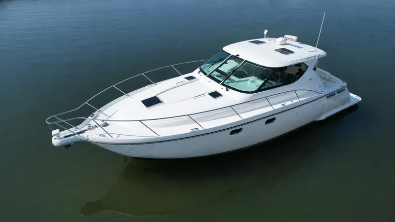 Slide: The Image of A 2006 Tiara Yachts 4300 Sovran on calm water, featuring a sleek white hull. - 1
