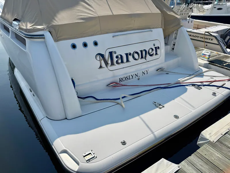 Slide: The Image of A 2006 Tiara Yachts 4300 Sovran docked with a beige cover and ropes. - 8