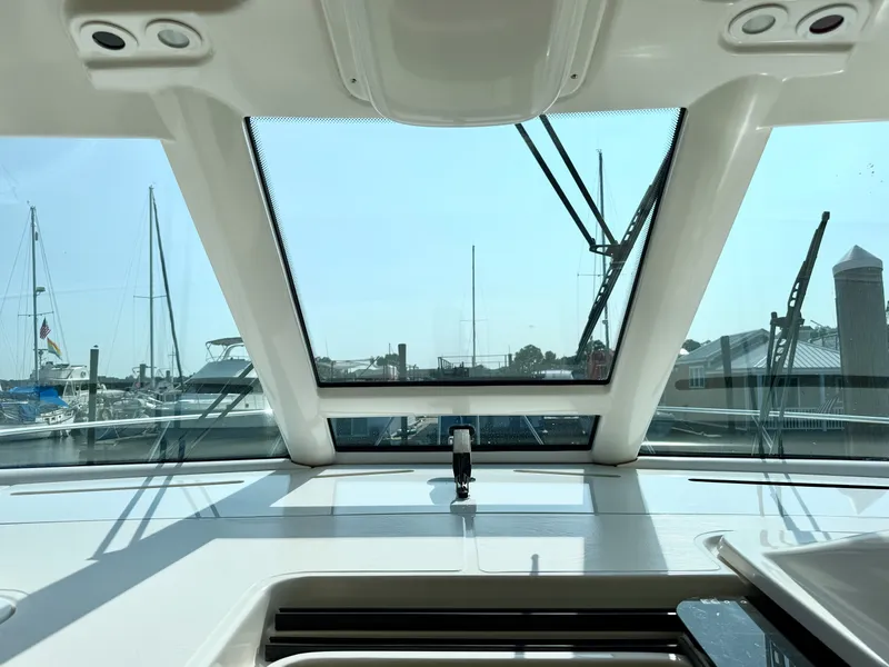 Slide: The Image of The cockpit of a 2006 Tiara Yachts 4300 Sovran overlooking a marina. - 36