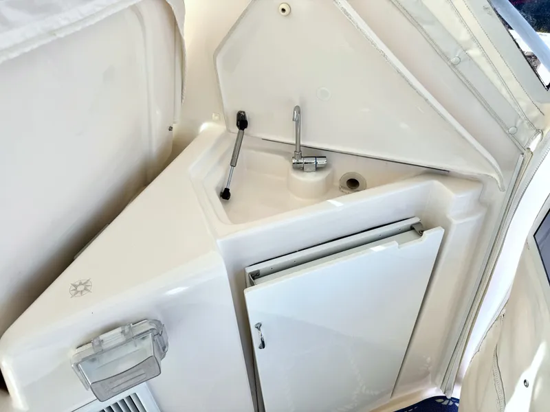Slide: The Image of The 2006 Tiara Yachts 4300 Sovran features a compact outdoor galley with a sink and refrigerator. - 25