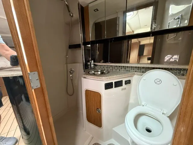 Slide: The Image of The image shows the bathroom of a 2013 Cruisers Yachts 380 Express with a toilet and sink. - 18