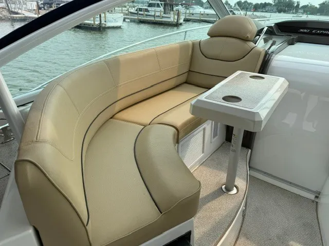 Slide: The Image of The image shows a beige upholstered seating area on a boat, with a small table beside it. - 8