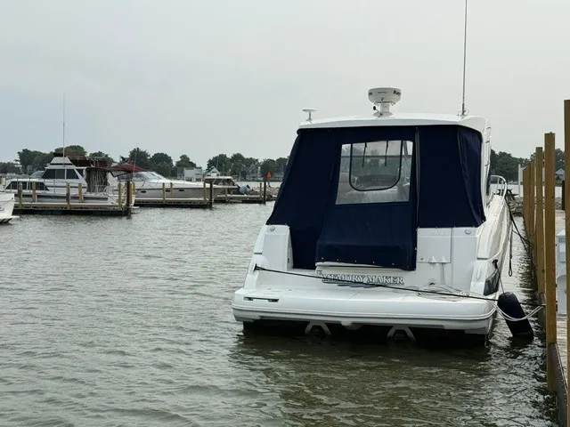 Slide: The Image of A 2013 Cruisers Yachts 380 Express docked in a marina, surrounded by other boats. - 3
