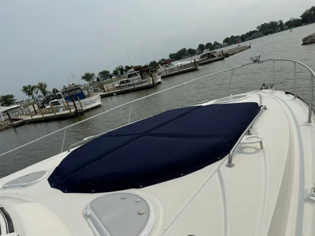 Slide: The Image of A 2013 Cruisers Yachts 380 Express docked at a calm harbor with several boats. - 5