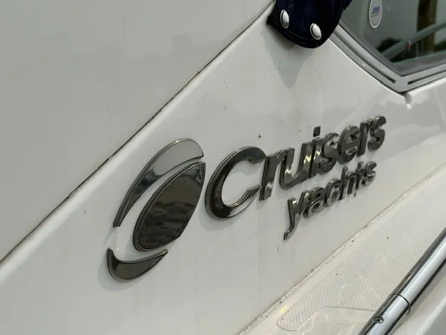 Slide: The Image of Close-up of the Cruisers Yachts logo on a white boat hull. - 4