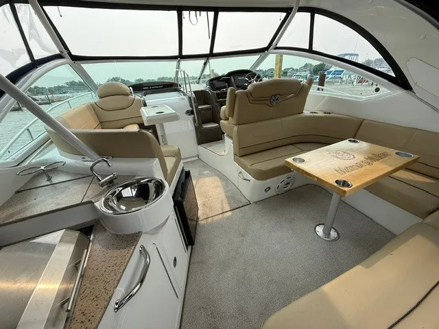 Slide: The Image of The image shows the cockpit of a 2013 Cruisers Yachts 380 Express with beige seating and a table. - 6