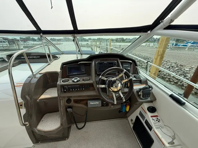 Slide: The Image of The cockpit of a 2013 Cruisers Yachts 380 Express with modern helm and instruments. - 11