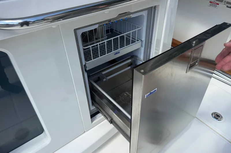 Slide: The Image of Open stainless steel refrigerator on 2024 Boston Whaler 420 Outrage boat. - 52