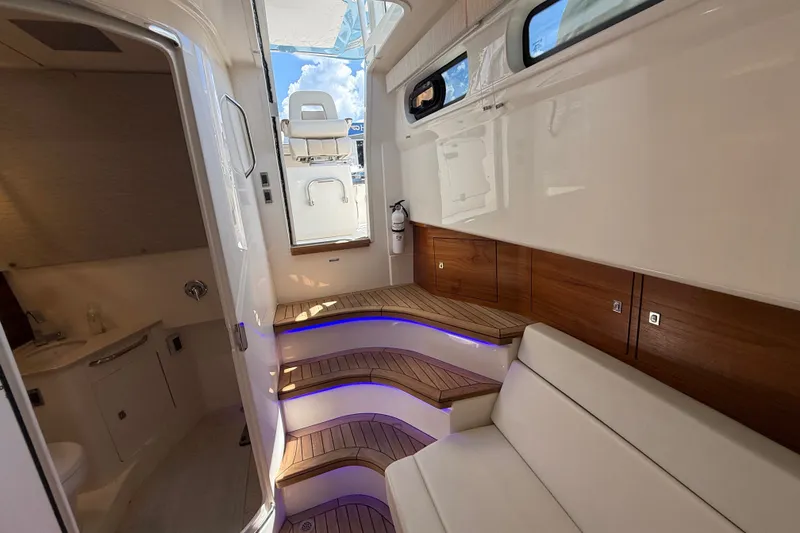 Slide: The Image of Luxurious interior of 2024 Boston Whaler 420 Outrage with elegant wood accents and seating. - 78