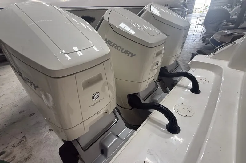 Slide: The Image of 2024 Boston Whaler 420 Outrage with triple Mercury outboard engines in a showroom. - 34