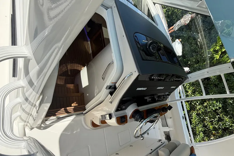 Slide: The Image of 2024 Boston Whaler 420 Outrage helm with modern controls and seating. - 63