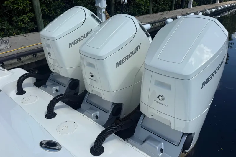 Slide: The Image of Triple Mercury Verado engines on a 2024 Boston Whaler 420 Outrage boat. - 51