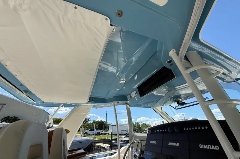 Slide: The Image of 2024 Boston Whaler 420 Outrage boat interior with blue ceiling and Simrad electronics. - 48