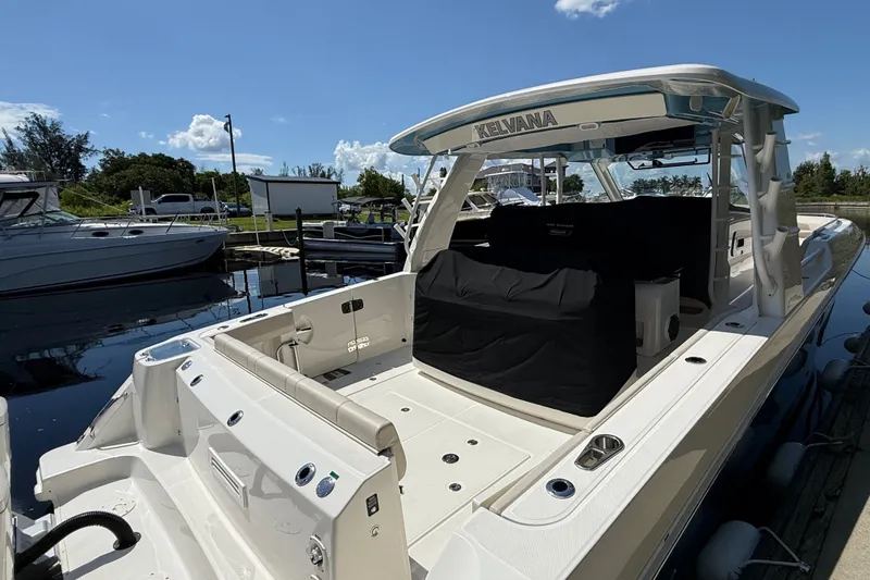 Slide: The Image of 2024 Boston Whaler 420 Outrage docked, showcasing spacious deck and sleek design. - 4