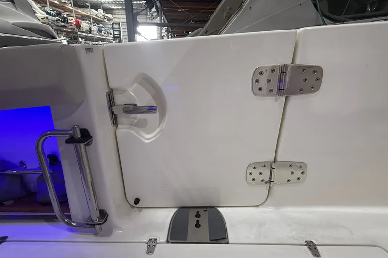 Slide: The Image of 2024 Boston Whaler 420 Outrage boat door with stainless steel hinges and handle. - 27