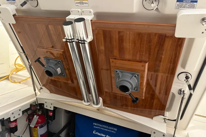 Slide: The Image of 2024 Boston Whaler 420 Outrage boat interior with polished wood paneling and equipment. - 24