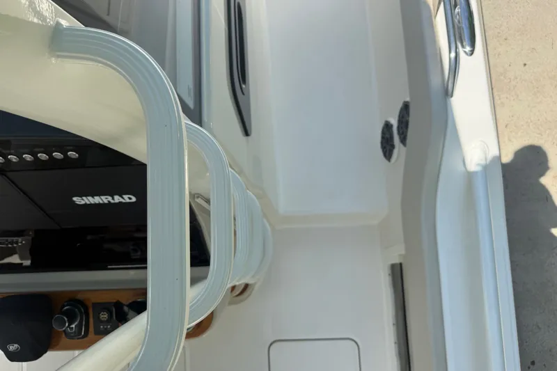 Slide: The Image of 2024 Boston Whaler 420 Outrage boat interior with Simrad electronics and sleek design elements. - 64