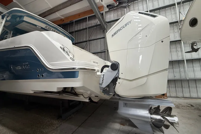 Slide: The Image of 2024 Boston Whaler 420 Outrage with Mercury outboard engine in a storage facility. - 31