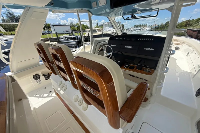Slide: The Image of 2024 Boston Whaler 420 Outrage helm with advanced navigation systems and luxurious seating. - 83