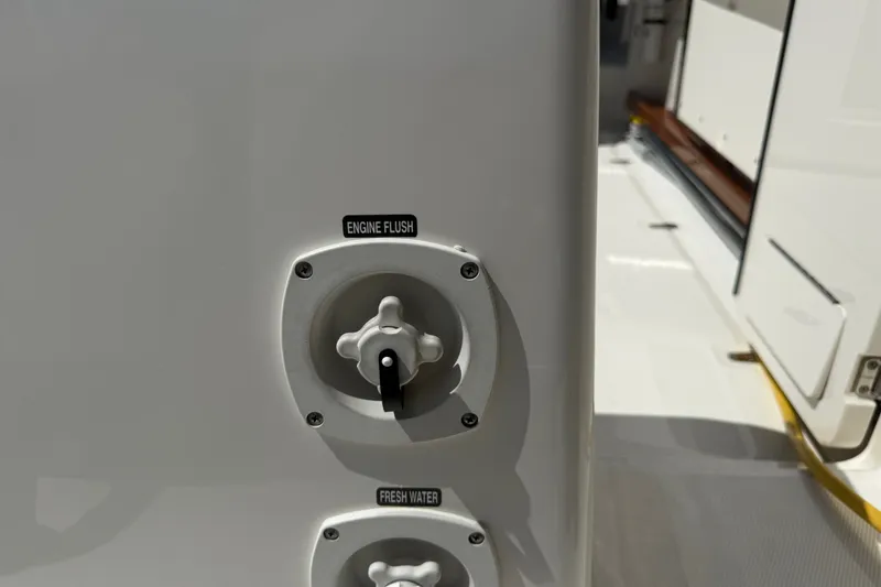 Slide: The Image of Boston Whaler 420 Outrage 2024 engine flush and fresh water controls. - 44