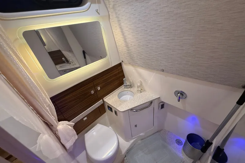 Slide: The Image of Luxurious bathroom interior of 2024 Boston Whaler 420 Outrage, featuring modern fixtures and elegant design. - 25