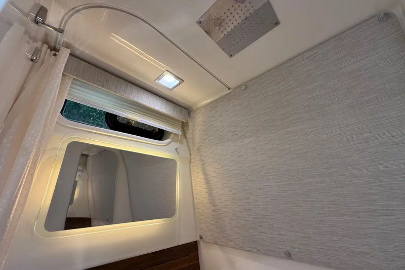 Slide: The Image of Interior cabin of 2024 Boston Whaler 420 Outrage with window and lighting. - 79