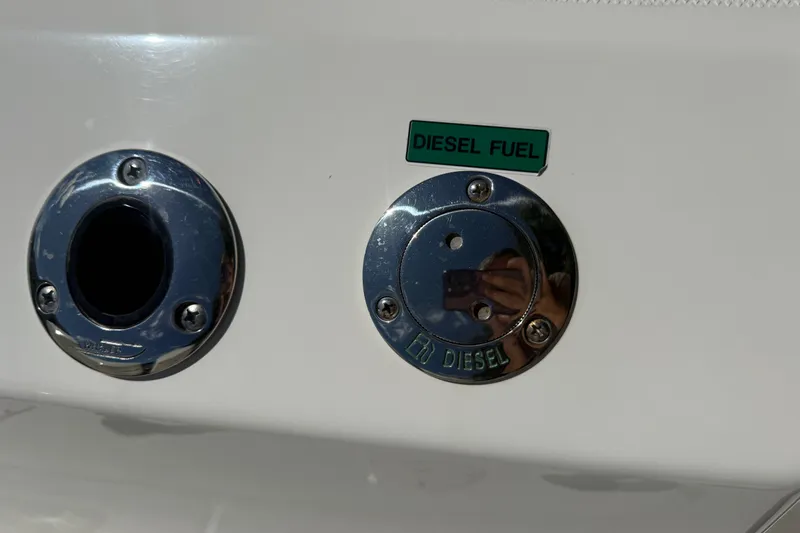 Slide: The Image of Diesel fuel port on 2024 Boston Whaler 420 Outrage boat. - 45