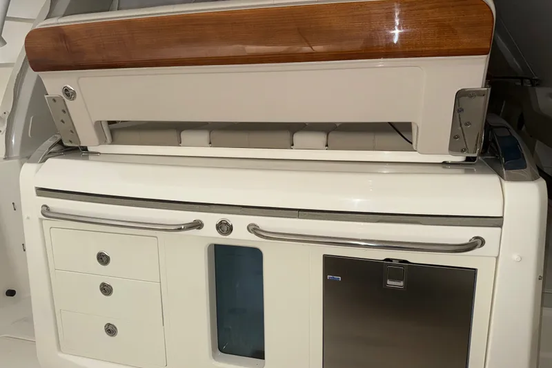 Slide: The Image of 2024 Boston Whaler 420 Outrage interior with sleek cabinetry and stainless steel accents. - 19