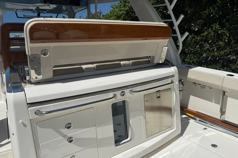 Slide: The Image of 2024 Boston Whaler 420 Outrage boat interior with sleek cabinetry and storage compartments. - 42